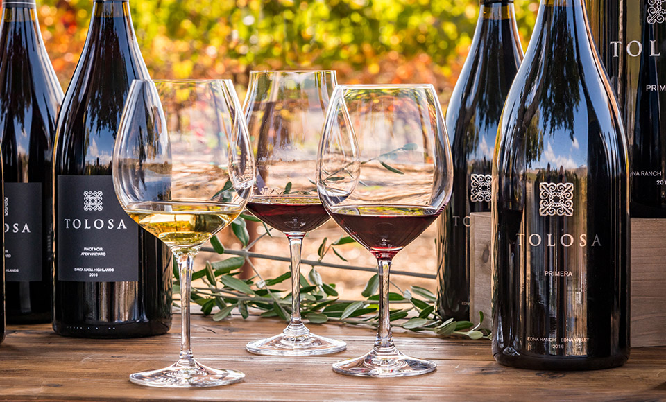 Single Vineyard and Primera Bottles with Wine Glasses