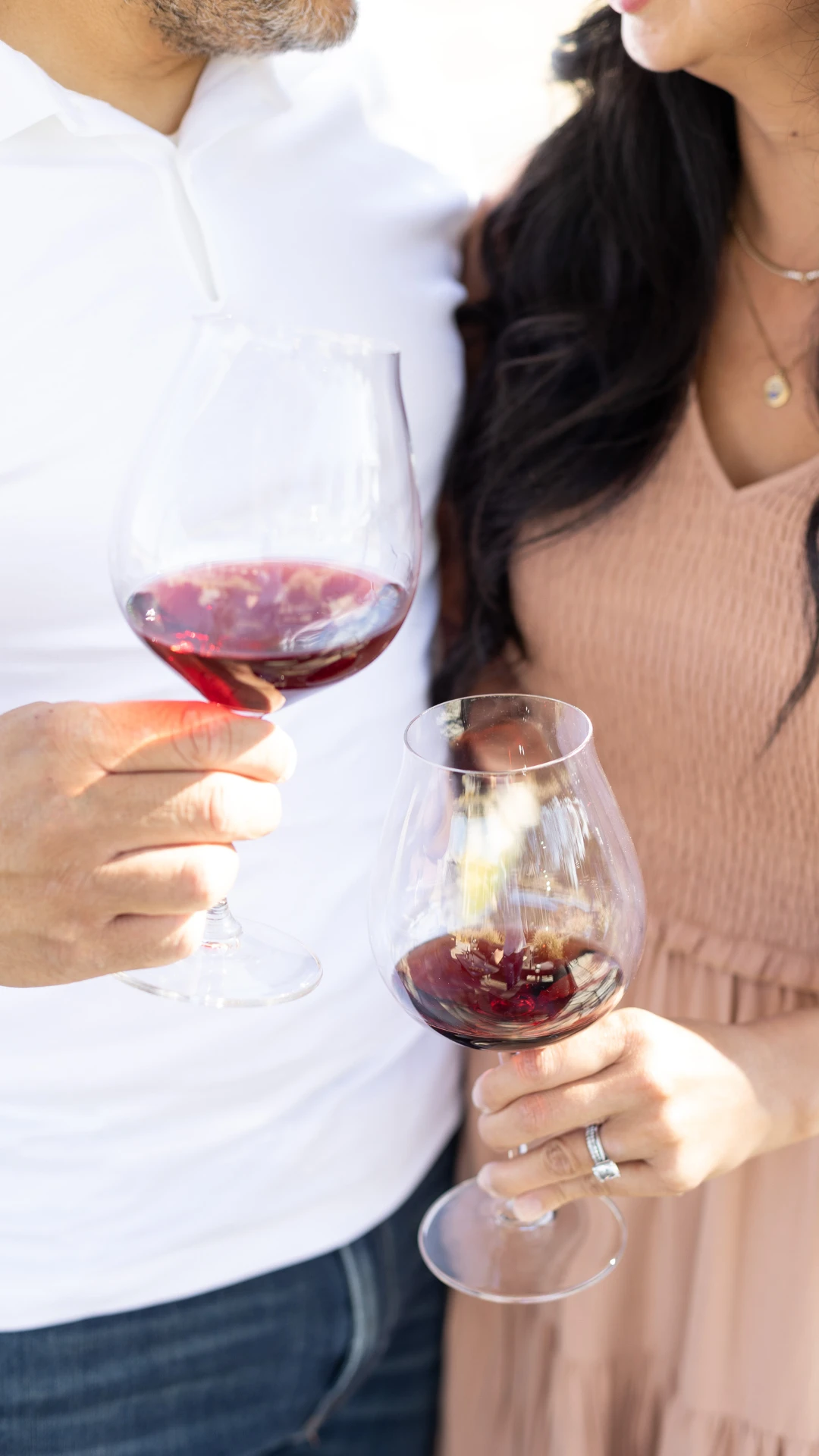 A couple holding glasses of Tolosa wine